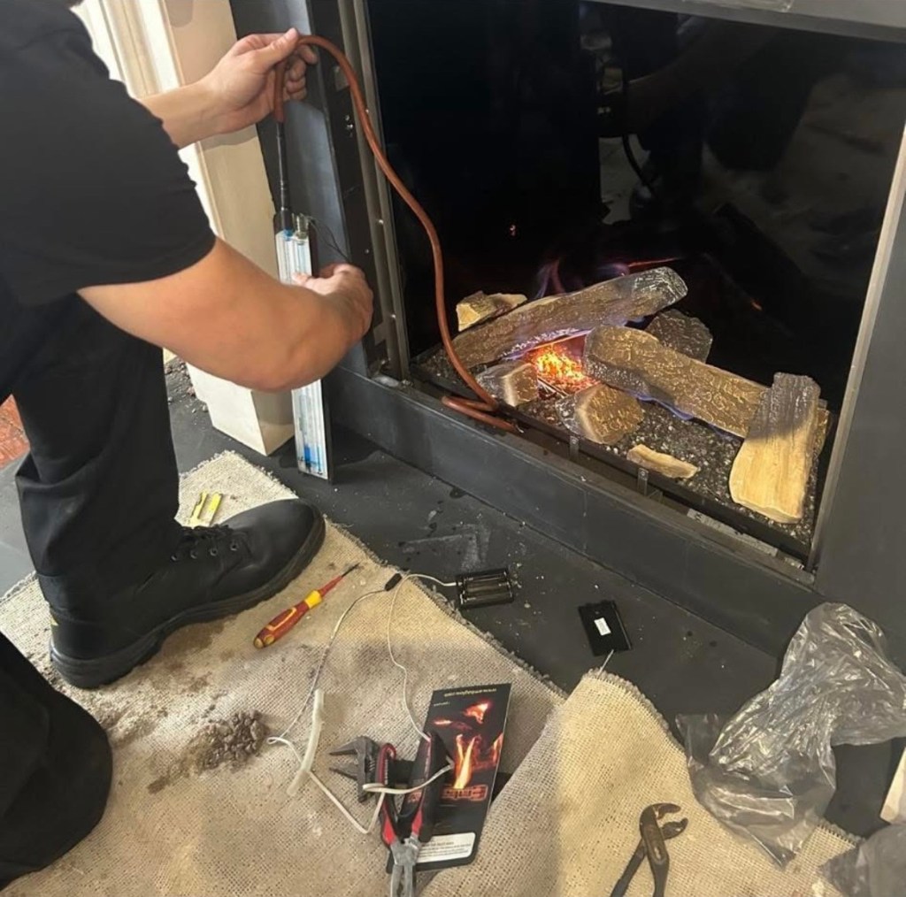 Gas engineer carrying out a safety check on a gas fire in Chester