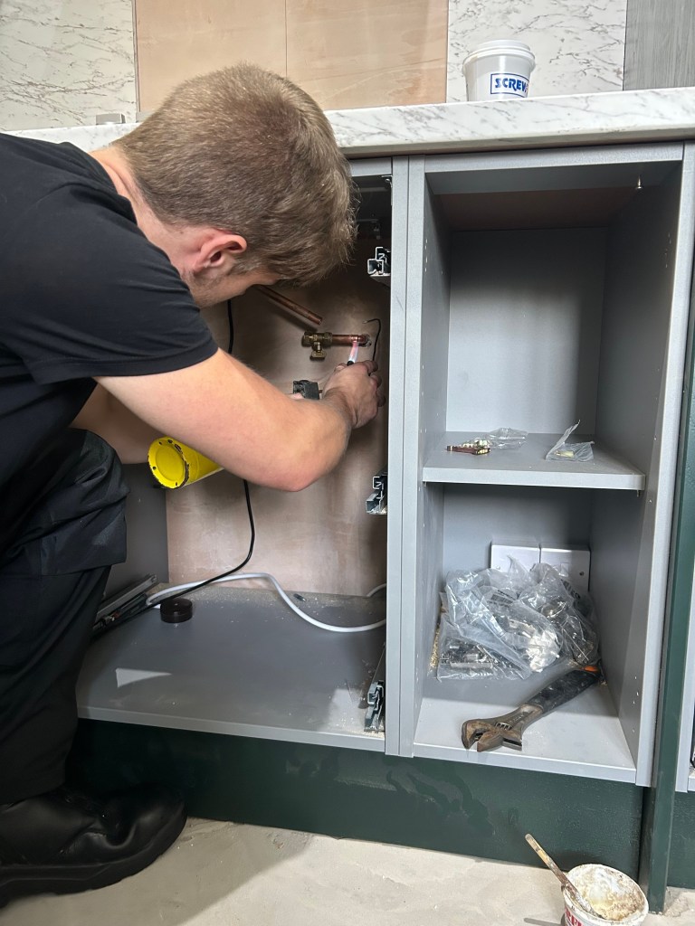 Gas engineer connecting the gas supply to a hob in Chester