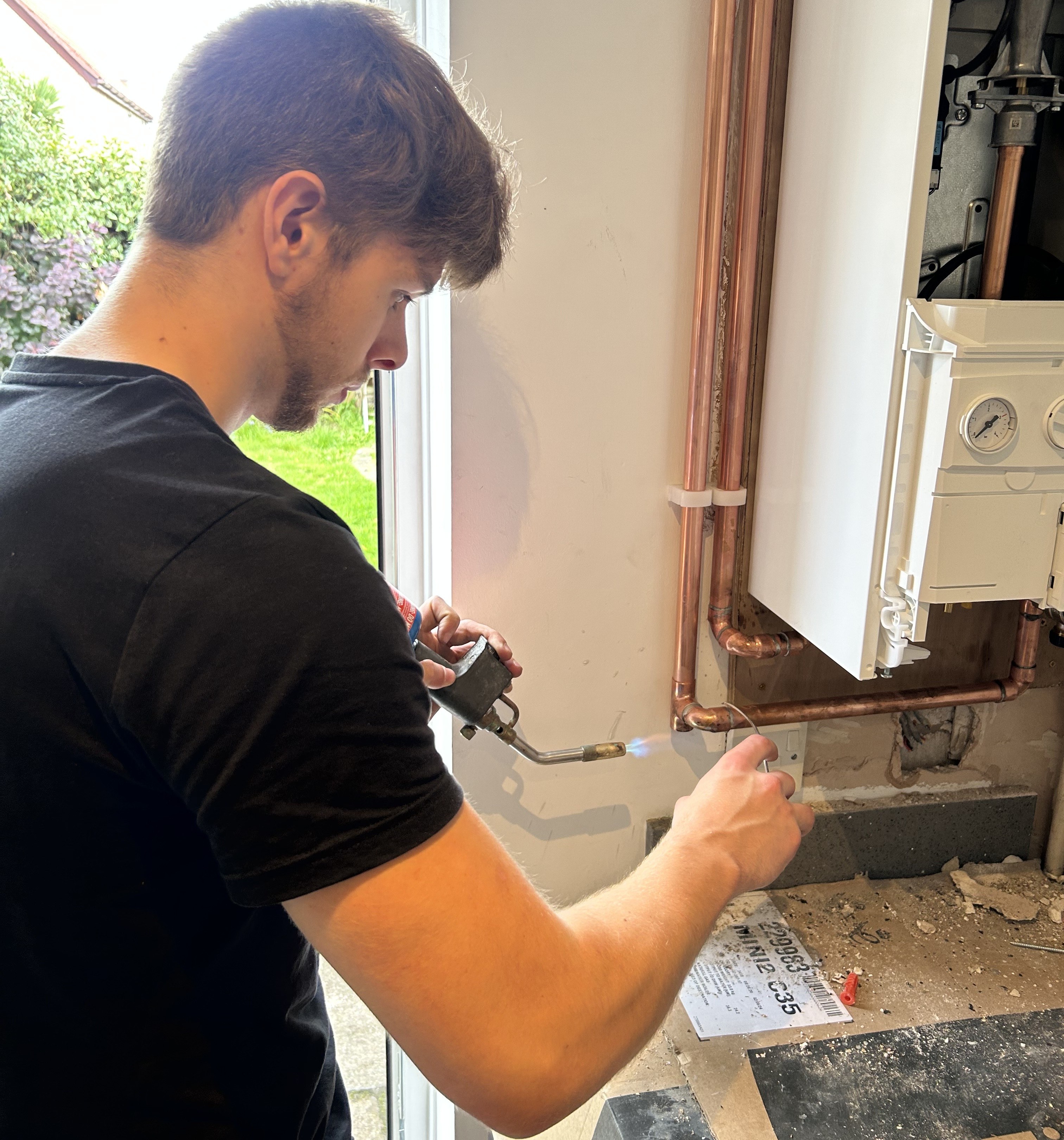 Gas engineer connecting the gas supply during an Ideal Logic boiler installation in Chester