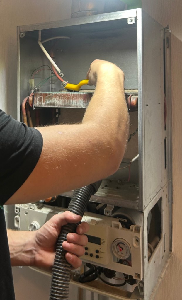 Gas engineer carrying out a Worcester Bosch boiler service in Chester