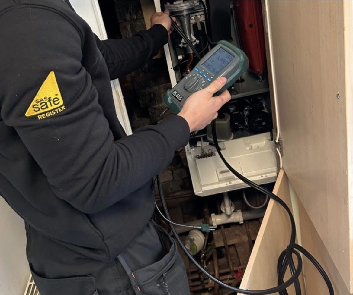 Gas engineer carrying out a gas safety check on an Ideal Logic boiler in Chester